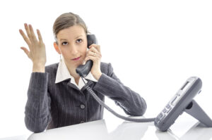 Frustrated Woman on hold on the telephone